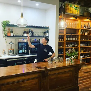a man pouring a glass of wine