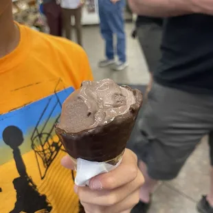 a boy holding an ice cream cone