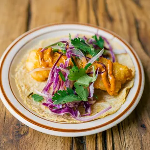 a plate of food on a wooden table