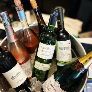 a bucket full of wine bottles