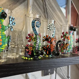 a row of glass vases on a shelf
