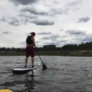 a man paddle boarding on a lake