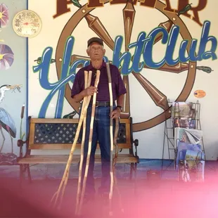 a man standing in front of a sign