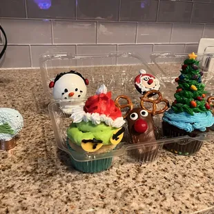 Reindeer cookie, Christmas tree cupcake, Santa Oreo, grinch cupcake, snowman hot cocoa bomb, and Oreo snow globe!