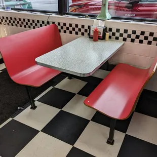 a table and two red chairs