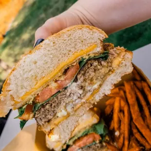 a hand holding a sandwich