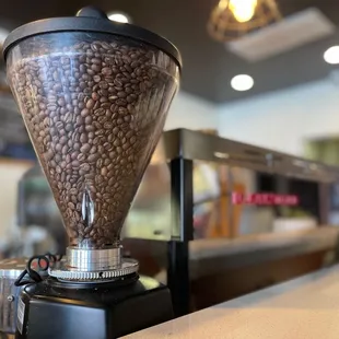 a coffee grinder filled with coffee beans
