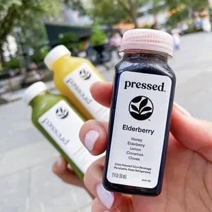 This location is a Pressed™ Post Hub, selling cold-pressed juices, wellness shots, and smoothies