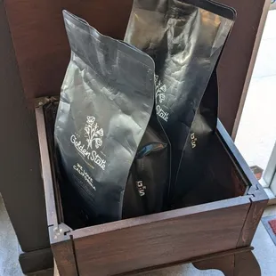two bags of ground coffee on a table