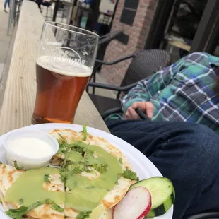 a plate of food and a glass of beer