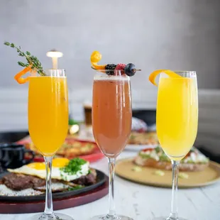 three cocktails on a table