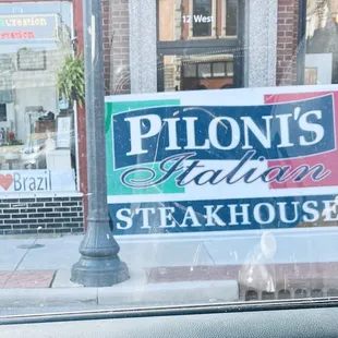 New sign going up today at Piloni's. I love Brazil. Welcome to Brazil!