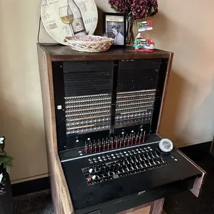 Entry way has an old phone switch board from the building.