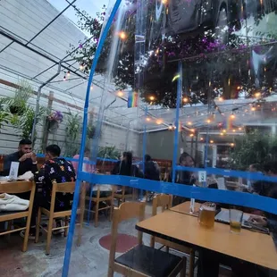 people sitting at tables in a restaurant