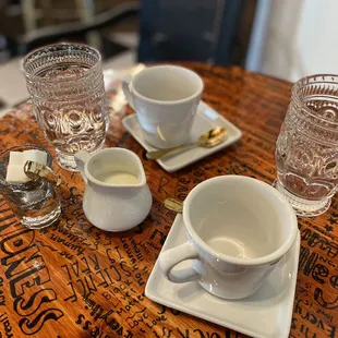 a table set with cups and saucers