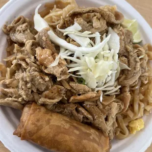 Chicken on noodles with a spring roll, at UNMC