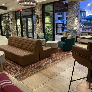 a living room with a couch and chairs