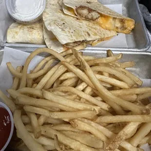 a tray of french fries and quesadillas