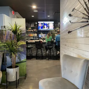 a golf club with a bar in the background