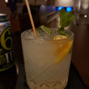 a glass of lemonade with a straw and mint