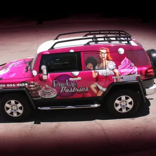 a pink jeep decorated with barbie dolls