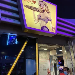 a woman holding a pizza