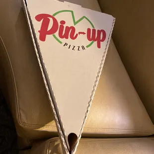 a triangle shaped pizza box