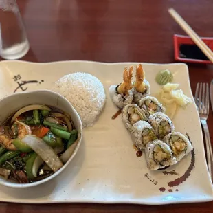 Shrimp tempura roll and shrimp with mixed vegetables in a spicy brown sauce.