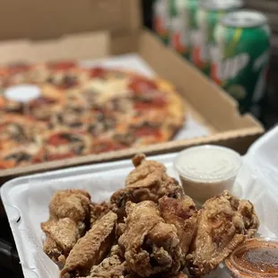Family Special: 12 Jumbo Buffalo Wings, Large Pizza, 4 cans soda of choice.