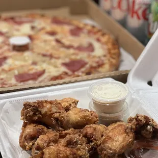 Family Special: Large Ham and Pineapple Pizza, Jumbo Buffalo Wings; includes four cans of soda.