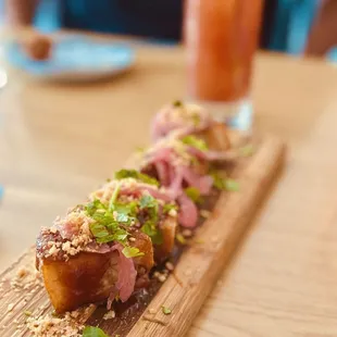 a long piece of meat on a cutting board