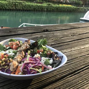 Chicken Kabob Bed of Greens with tabouli, red and green cabbage slaw, corn and feta.