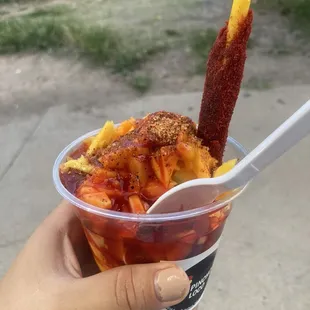 Mangonada (mango sherbet, mango pieces, hot sauce, tamarind straw)