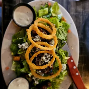 A wonderful Steak Salad with onion rings &amp; blue cheese crumbles. I sub blue cheese dressing instead of casear!