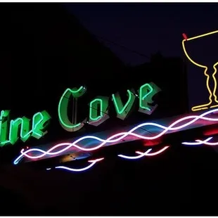 the neon sign for pine cove