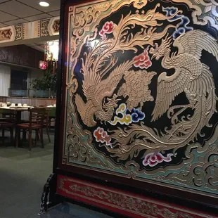 a large oriental screen in the dining room