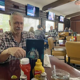 My husband enjoying fish and chips plus a salad.