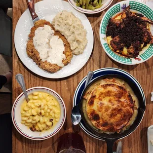 a wooden table with plates of food