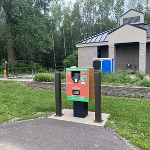 Pay machine, bathrooms behind, bike fix station on right