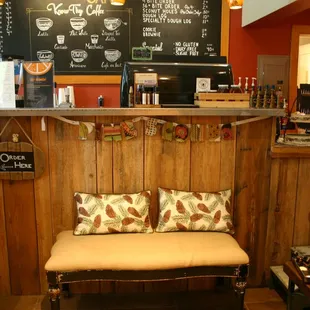 a wooden bench with two pillows