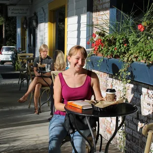 a woman sitting at a table and smiling