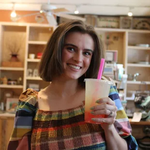 a woman holding a drink