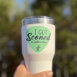 a hand holding a cup