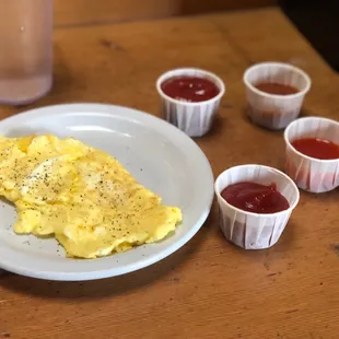 Scrambled eggs with ketchup and two hot sauces - one was a habanero hot sauce, the other was a Buffalo sauce