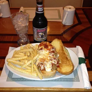 a plate of food and a bottle of beer