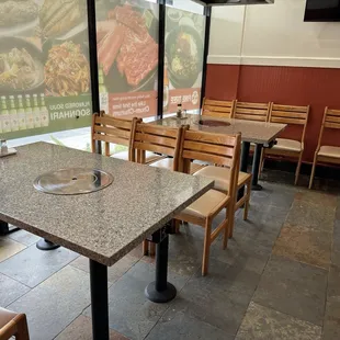 New interior - this front area use to have 4 booths, and now after the remodel it has 4 grill tables with chairs. (July 2024)