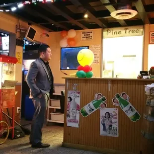 a man standing in front of a bar