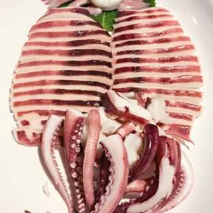a plate of sliced squids on a white plate