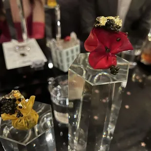 a glass vase with a flower in it