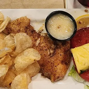 Triple tail sandwich (custom order - no onion, no bun, &amp; pineapple sauce in place of tarter) kettle chips are included.